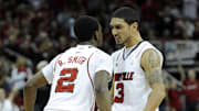 Dec 23, 2011; Louisville, KY, USA;  Louisville Cardinals guard Peyton Siva (3) celebrates with guard Russ Smith (2) during the second half against the Western Kentucky Hilltoppers at the KFC Yum! Center.  Louisville defeated Western Kentucky 70-60.  Credit: Jamie Rhodes-Imagn Images