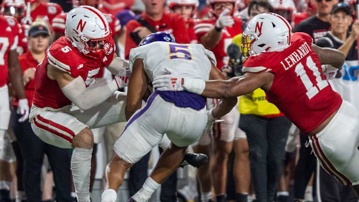 Nebraska defenders John Bullock and Cameron Lenhardt combine to bring down Northern Iowa running back Amauri Pesek-Hickson.