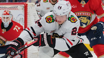 Oct 7, 2025; Sunrise, Florida, USA; Chicago Blackhawks center Sam Lafferty (24) moves the puck against Florida Panthers center Anton Lundell (15) during the second period at Amerant Bank Arena. Mandatory Credit: Sam Navarro-Imagn Images
