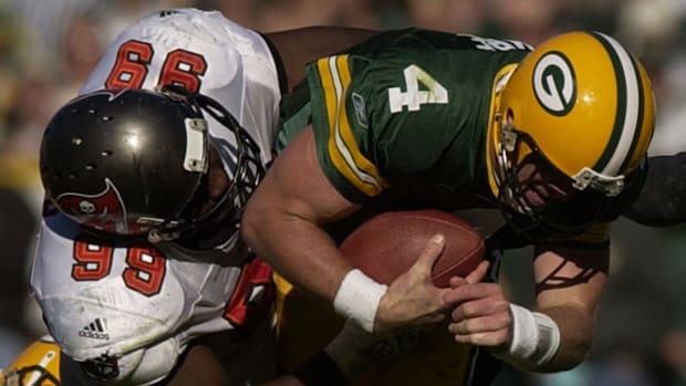 Packers quarterback Brett Favre is tackled by Bucs defensive tackle Warren Sapp on a 3-yard run during the second quarter on 