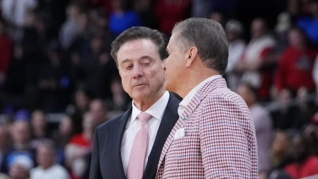 St. John's Red Storm coach Rick Pitino and Arkansas Razorbacks coach John Calipari shake hands as the Razorbacks won a second