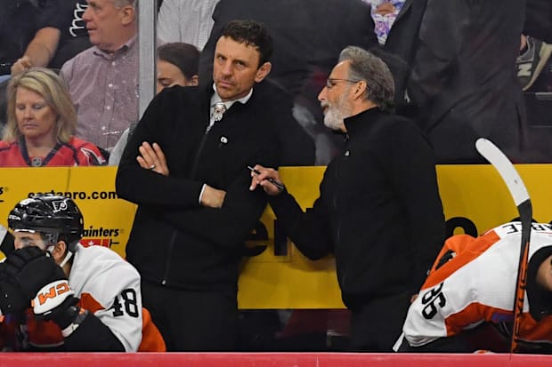 Hockey coach talks to assistant on the benc
