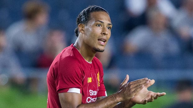 Virgil van Dijk urges on his team in the second half of a preseason preparation soccer match against the Borussia Dortmund.
