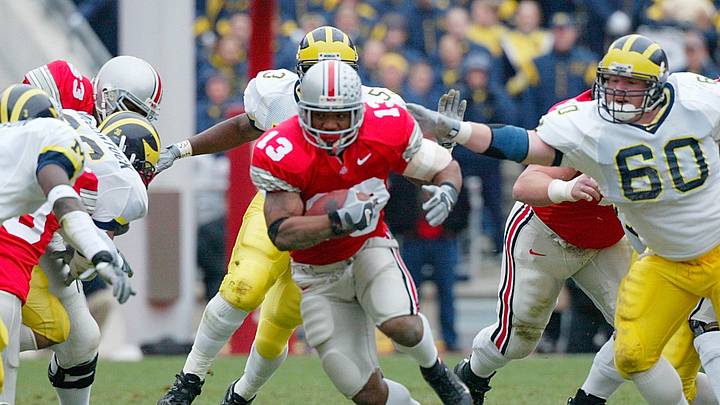 Ohio State's Maurice Clarett, 13, tries to avoid the Michigan defense during their game at the Ohio Stadium , November 23, 2002.