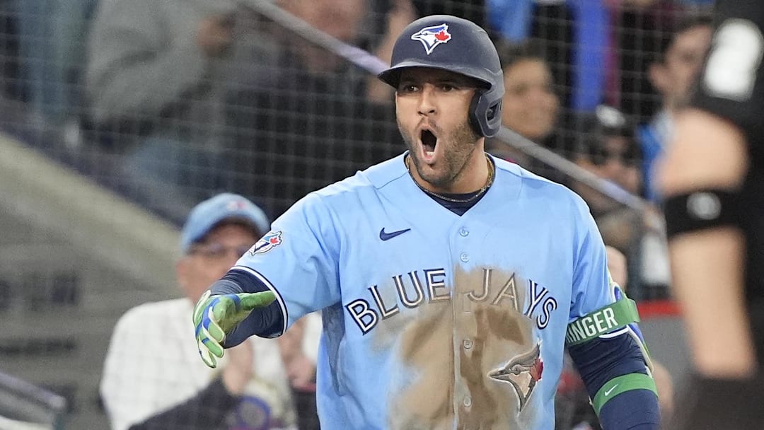 Blue Jays designated hitter George Springer (4) reacts after left fielder Davis Schneider (not pictured) scores the winning run against the Los Angeles Dodgers during the eighth inning at Rogers Centre