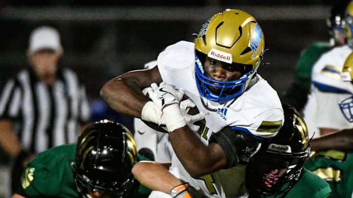 Taevion Swint of Osceola is tackled by a pair of Viera defenders during their game Tuesday, October 15, 2024. The game was delayed from last Friday due to Hurricane Milton. Craig Bailey/FLORIDA TO2AY via USA TODAY NETWORK