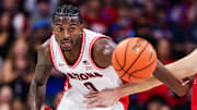 Nov 7, 2025; Tucson, Arizona, USA; Arizona Wildcats guard Jaden Bradley (0) and Utah Tech Trailblazers guard Chanced Trujillo (2) both chase after the ball during the second half of the game at McKale Memorial Center. Mandatory Credit: Aryanna Frank-Imagn Images