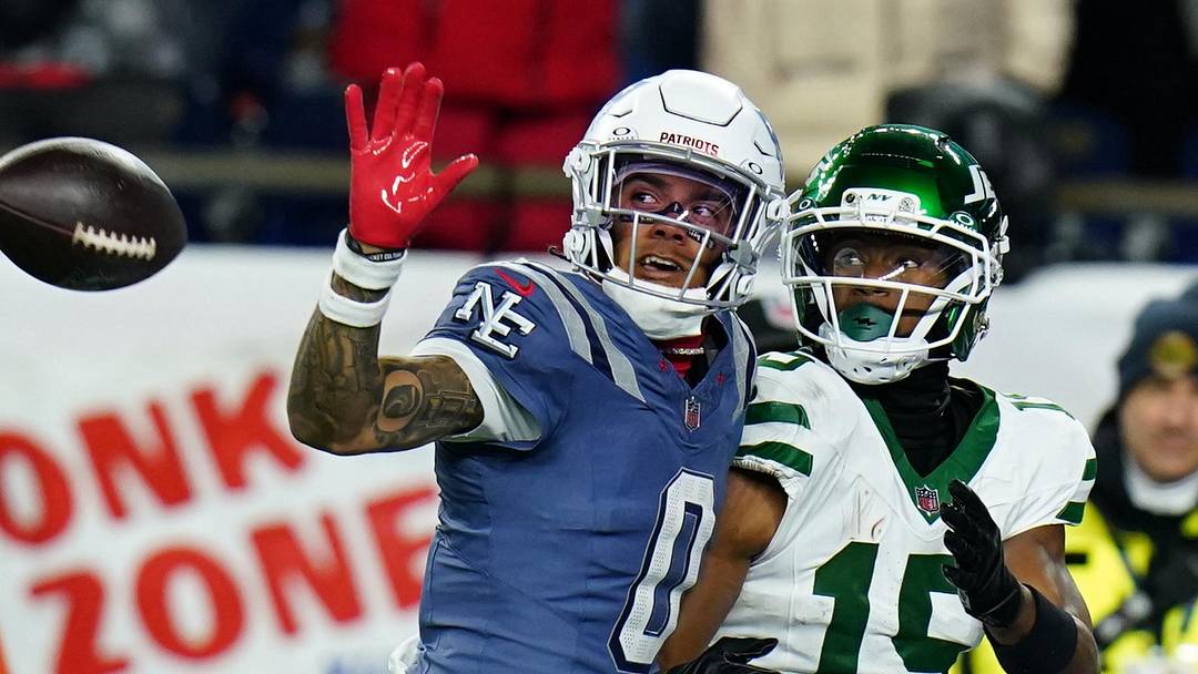 Nov 13, 2025; Foxborough, Massachusetts, USA; New England Patriots Christian Gonzalez cornerback (0) defends against New York Jets wide receiver Adonai Mitchell (15) in the fourth quarter at Gillette Stadium. Mandatory Credit: David Butler II-Imagn Images
