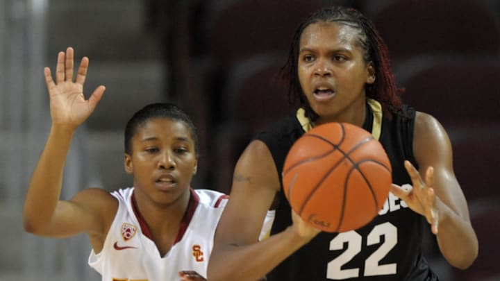 Dec 18, 2010; Los Angeles, CA, USA; Colorado Buffaloes forward Brittany Spears (22) is defended by Southern California Trojans guard Len'Nique Brown (14) in the 2010 Women of Troy tournament at the Galen Center. USC defeated Colorado 68-54. Mandatory Credit: Kirby Lee/Image of Sport-Imagn Images
