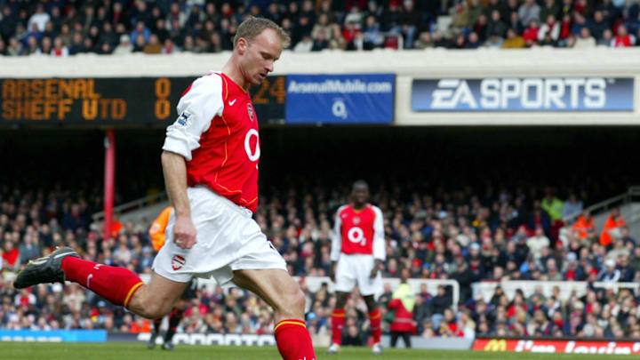 Arsenal's Dennis Bergkamp takes a shot a