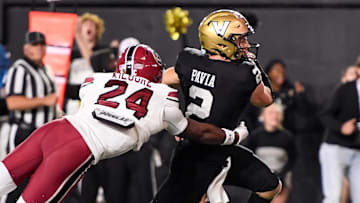 Nov 9, 2024; Nashville, Tennessee, USA;  Vanderbilt Commodores quarterback Diego Pavia (2) scores past South Carolina Gamecocks defensive back Jalon Kilgore (24) during the second half at FirstBank Stadium. Mandatory Credit: Steve Roberts-Imagn Images