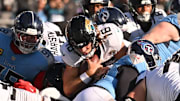 Nov 30, 2025; Nashville, Tennessee, USA; Jacksonville Jaguars quarterback Trevor Lawrence (16) carries the ball for a first down against the Tennessee Titans during the second half at Nissan Stadium. Mandatory Credit: Steve Roberts-Imagn Images
