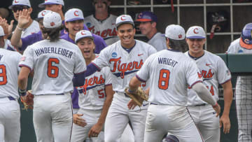 Jun 2, 2024; Clemson, South Carolina, USA; Clemson teammates smile as senior Blake Wright (8) comes in the dugout, after an inning in which Wright pulled off a hidden ball trick to get an out during the top of the second inning of the NCAA baseball Clemson Regional at Doug Kingsmore Stadium in Clemson Mandatory Credit: Ken Ruinard-USA TODAY Sports