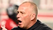 Nov 4, 2023; Raleigh, North Carolina, USA;  North Carolina State Wolfpack head coach Dave Doeren encourages his team as they warm up prior to a game against the Miami Hurricanes at Carter-Finley Stadium. Mandatory Credit: Rob Kinnan-Imagn Images