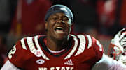 Nov 26, 2021; Raleigh, North Carolina, USA; North Carolina State Wolfpack linemen Grant Gibson (50) and Timothy McKay (52) celebrate after beating the North Carolina Tar Heels at Carter-Finley Stadium.  The Wolfpack won 34-30. Mandatory Credit: Rob Kinnan-Imagn Images