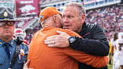 Arkansas coach Sam Pittman and Texas coach Steve Sarkisian meet postgame after the Longhorns defeat the Razorbacks 20-10