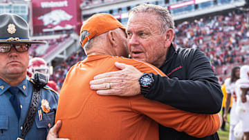 Arkansas coach Sam Pittman and Texas coach Steve Sarkisian meet postgame after the Longhorns defeat the Razorbacks 20-10