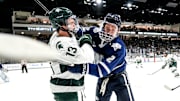 Michigan State's Tiernan Shoudy, left, battles with New Hampshire's Alex Carr during the first period on Thursday, Oct. 9, 2025, at Munn Ice Arena in East Lansing.