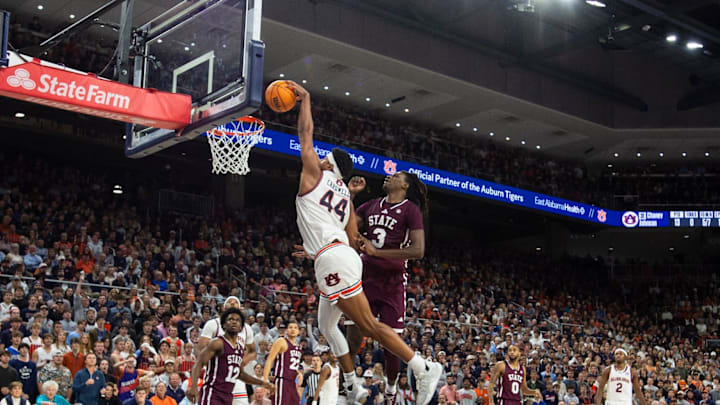 Auburn Tigers center Dylan Cardwell (44) is fouled as he attempts a dunk over Mississippi State Bulldogs forward KeShawn Murphy (3) as Auburn Tigers take on Mississippi State Bulldogs at Neville Arena in Auburn, Ala., on Tuesday, Jan. 14, 2025. Auburn Tigers defeated Mississippi State Bulldogs 88-66.