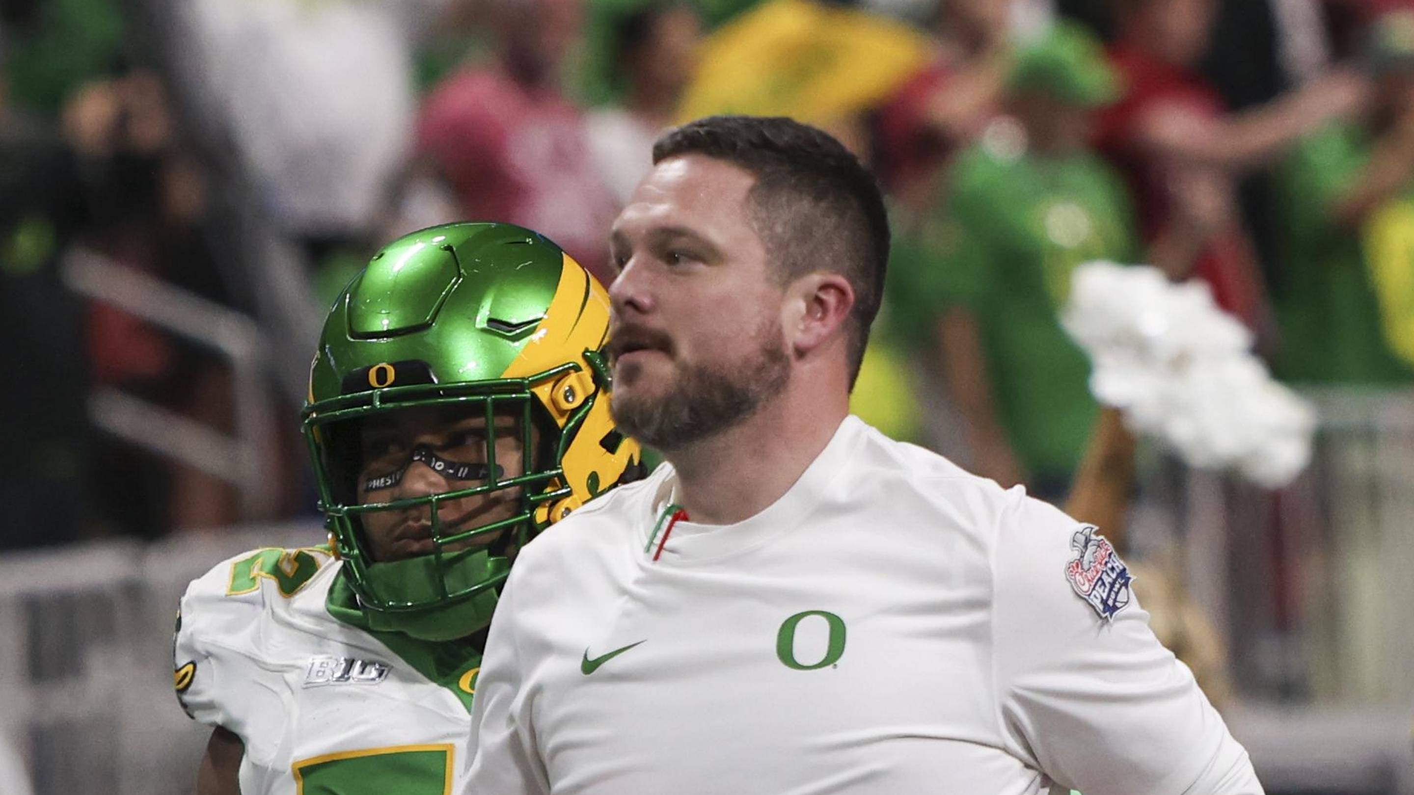 Jan 9, 2026; Atlanta, GA, USA; Oregon Ducks head coach Dan Lanning leads his team onto the field prior to the 2025 Peach Bowl and semifinal game of the College Football Playoff against the Indiana Hoosiers at Mercedes-Benz Stadium. Mandatory Credit: Brett Davis-Imagn Images