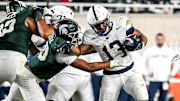 Michigan State's Wayne Matthews III, left, tackles Penn State's Kaytron Allen during the fourth quarter on Saturday, Nov. 15, 2025, at Spartan Stadium in East Lansing.