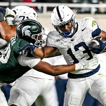 Michigan State's Wayne Matthews III, left, tackles Penn State's Kaytron Allen during the fourth quarter on Saturday, Nov. 15, 2025, at Spartan Stadium in East Lansing.