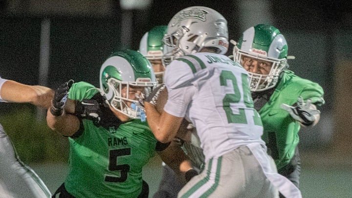 St. Mary’s Diego Hernandez, left, and Malakai Maka close in on De Las Salle’s Duece Jones-Drew during a during a varsity football game at St. Mary’s in Stockton on Sep. 20, 2024. De La Salle won 38-35.