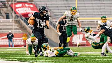 Darlington quarterback Zeke Zuberbuhler (13) sprints down the right side line during the WIAA Division 6 state championship game.