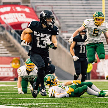 Darlington quarterback Zeke Zuberbuhler (13) sprints down the right side line during the WIAA Division 6 state championship game.
