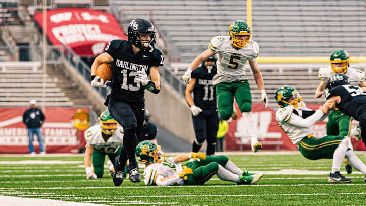 Darlington quarterback Zeke Zuberbuhler (13) sprints down the right side line during the WIAA Division 6 state championship game. Darlington quarterback Zeke Zuberbuhler (13) sprints down the right side line during the WIAA Division 6 state championship game.