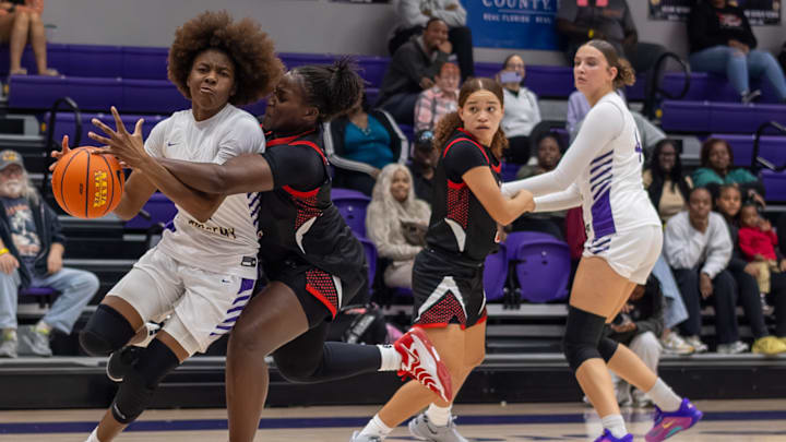 Montverde Academy forward Jamila Ray, far left, attempts to drive the ball in for a basket in a recent game. The 5-foot-11 senior had 24 points and 10 rebounds for a double-double to guide the Eagles past Ocoee, 57-41, in a battle of two of Florida’s best teams.