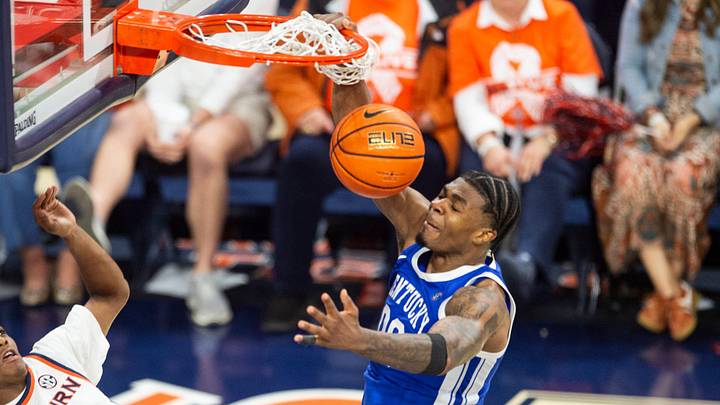 Kentucky Wildcats guard Otega Oweh (00) dunks over Auburn Tigers guard Tahaad Pettiford (0) as Auburn Tigers take on Kentucky Wildcats at Neville Arena in Auburn, Ala. on Saturday, Feb. 21, 2026. Kentucky Wildcats leads Auburn Tigers 39-35 at halftime.