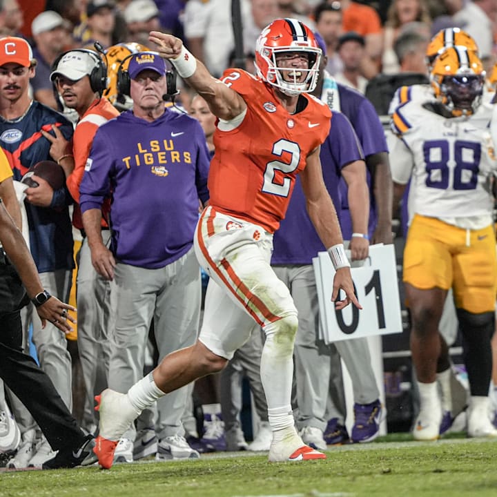Clemson quarterback Cade Klubnik reacts near LSU head coach Brian Kelly on sidelines after getting a first down 