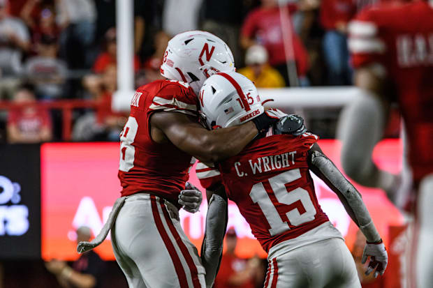 MJ Sherman (left) hugs Ceyair Wright (15) after Wright's strip-sack for Nebraska to recover a fumble in the third quarter.  