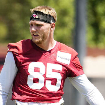 Arizona Cardinals tight end 	Trey McBride (85) talks to quarterback Jacoby Brissett (7) during organized team practice at the Arizona Cardinals training center in Tempe on June 3, 2025.
