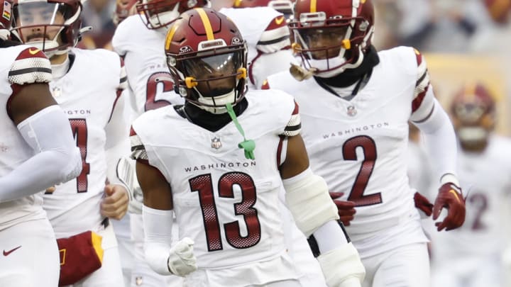 Jan 7, 2024; Landover, Maryland, USA; Washington Commanders cornerback Emmanuel Forbes (13) runs onto the field with teammates prior to their game against the Dallas Cowboys at FedExField. Mandatory Credit: Geoff Burke-USA TODAY Sports