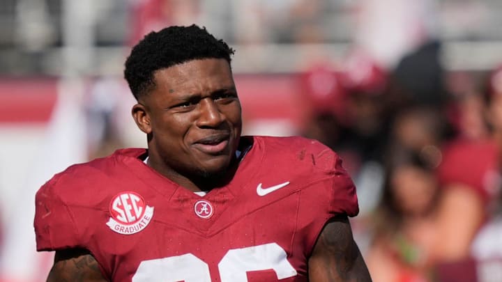 Nov 22, 2025; Tuscaloosa, Alabama, USA; Alabama running back Jam Miller (26) walks to his family with a rose in hand on Senior Day at Saban Field at Bryant-Denny Stadium.