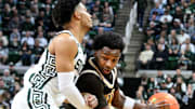 Dec 30, 2024; East Lansing, Michigan, USA; Western Michigan Broncos guard Chansey Willis Jr. (2) gets trapped by Michigan State Spartans guard Jaden Akins (3) during the first half  at Jack Breslin Student Events Center. Mandatory Credit: Dale Young-Imagn Images