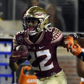 Florida State's Ja'hi Douglas stiff-arms Avantae Williams in 2021.