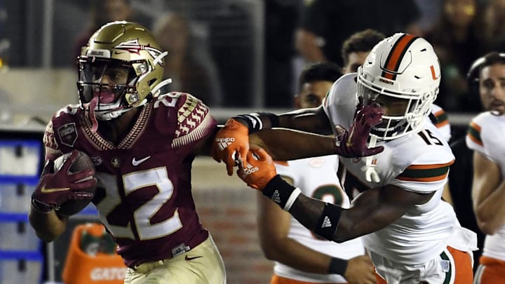 Florida State's Ja'hi Douglas stiff-arms Avantae Williams in 2021. Florida State's Ja'hi Douglas stiff-arms Avantae Williams in 2021.