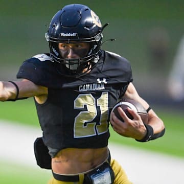 Canadian running back Slayden Dickinson fends off a tackle from a Bushland defender in a game held Sep 5.