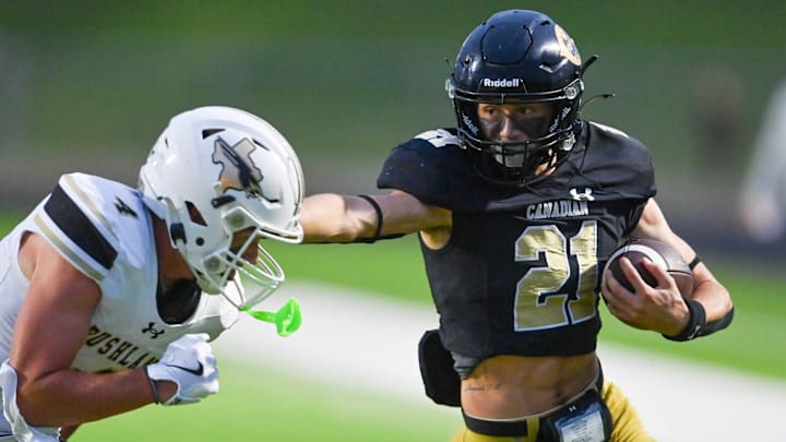 Canadian running back Slayden Dickinson fends off a tackle from a Bushland defender in a game held Sep 5. Canadian running back Slayden Dickinson fends off a tackle from a Bushland defender in a game held Sep 5.