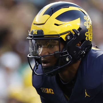 Aug 31, 2024; Ann Arbor, Michigan, USA;  Michigan Wolverines quarterback Alex Orji (10) gets set to run a play in the first half against the Fresno State Bulldogs at Michigan Stadium. Mandatory Credit: Rick Osentoski-Imagn Images