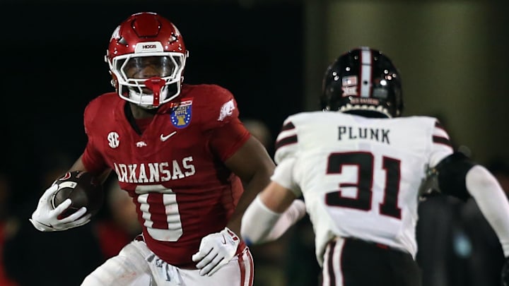 Dec 27, 2024; Memphis, TN, USA; Arkansas Razorbacks running back Braylen Russell (0) runs the ball during the third quarter against the Texas Tech Red Raiders at Simmons Bank Liberty Stadium. Mandatory Credit: Petre Thomas-Imagn Images