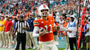Nov 8, 2025; Miami Gardens, Florida, USA; Miami Hurricanes quarterback Carson Beck (11) catches a touchdown pass against the Syracuse Orange during the second quarter at Hard Rock Stadium. Mandatory Credit: Jeff Romance-Imagn Images