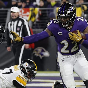 Jan 11, 2025; Baltimore, Maryland, USA; Baltimore Ravens running back Derrick Henry (22) carries the ball as Pittsburgh Steelers linebacker Payton Wilson (41) chases in an AFC wild card game at M&T Bank Stadium. Mandatory Credit: Geoff Burke-Imagn Images