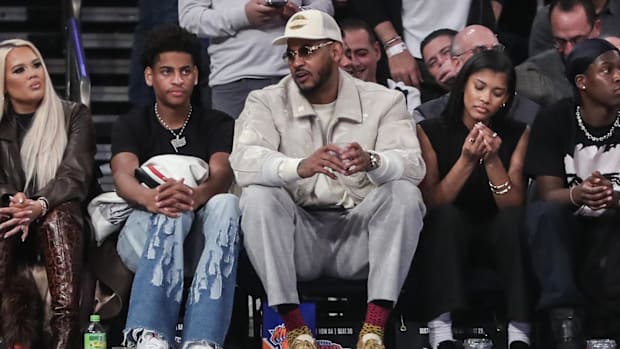 Carmelo Anthony sits with his son Kiyan Anthony, a four-star Syracuse commit, at the Boston Celtics-New York Knicks game at M
