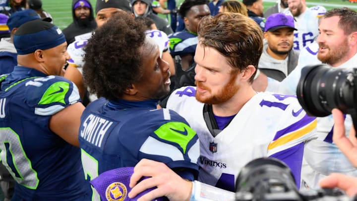 Dec 22, 2024; Seattle, Washington, USA; Seattle Seahawks quarterback Geno Smith (7) and Minnesota Vikings quarterback Sam Darnold (14) hug after the game at Lumen Field. Dec 22, 2024; Seattle, Washington, USA; Seattle Seahawks quarterback Geno Smith (7) and Minnesota Vikings quarterback Sam Darnold (14) hug after the game at Lumen Field.