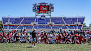 Florida Atlantic University Football Head Coach Tom Herman talks to the team after a game at FAU Stadium in April 2024.