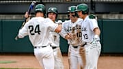 Michigan State's Sam Busch, left, crosses home plate after a home run against Ohio State during the fifth inning on Friday, April 18, 2025, at McLane Stadium in East Lansing. From left, MSU's Ryan McKay, Nick Williams and Parker Picot greet Bush at the plate.